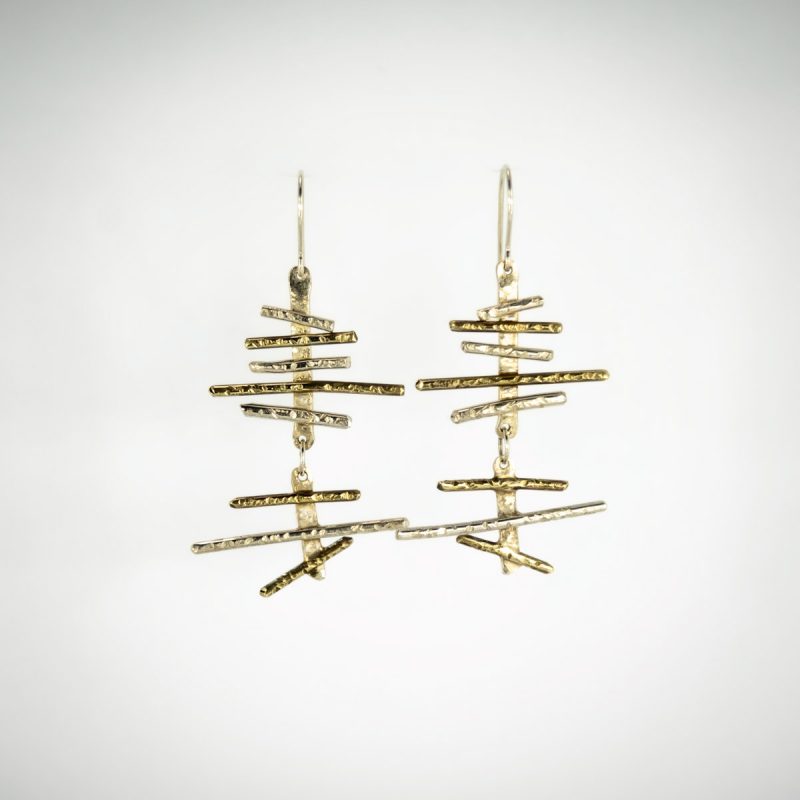 These saucy Haywired Silver and Brass Earrings love to dangle around! They have hand hammered textures, are oxidized creating a rich contrast between the silver and brass. These earrings have a polished finish and are a stunning look for anyone who adorns the Haywired Silver and Brass Earrings!