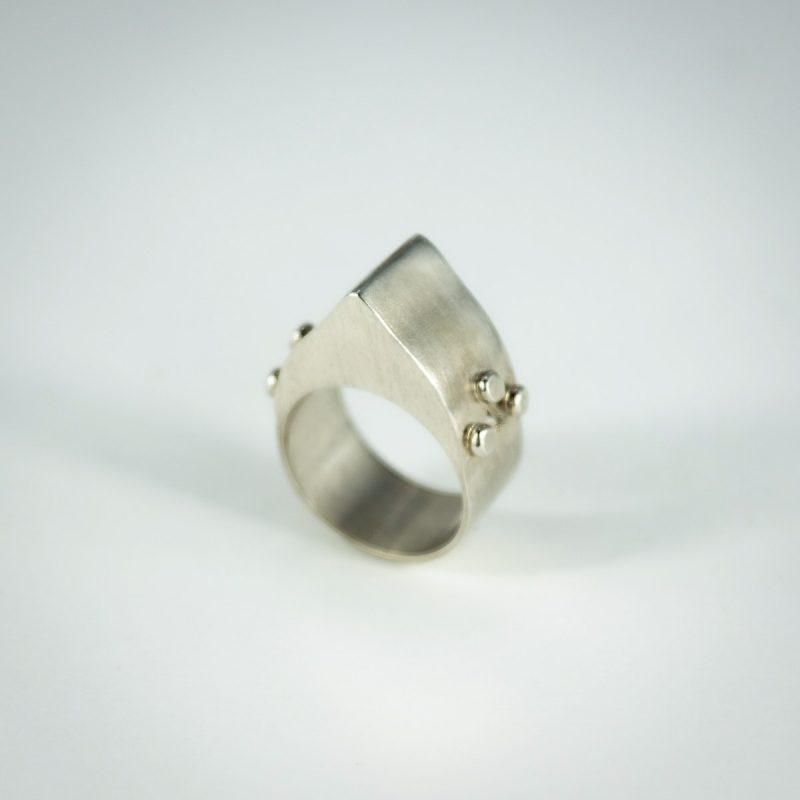 This modern Hollow Form Statement Ring is bound to turn heads! It’s asymmetrical design is satisfyingly bold and light-weight due to its hollow form construction. Made from sterling silver and is completed with a satin finish, it is smooth fitting and comfortable. Side angle view.