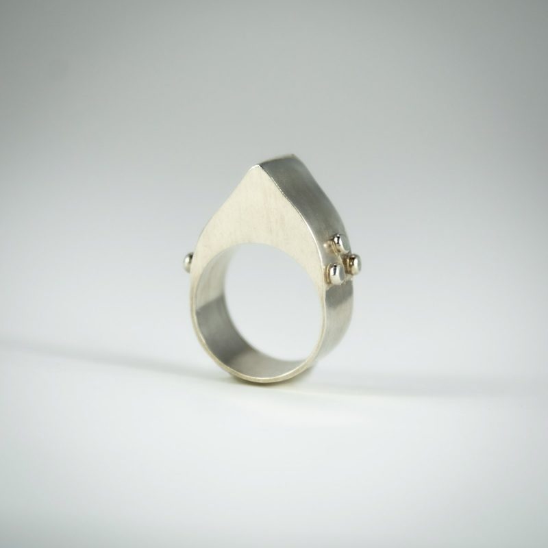 This modern Hollow Form Statement Ring is bound to turn heads! It’s asymmetrical design is satisfyingly bold and light-weight due to its hollow form construction. Made from sterling silver and is completed with a satin finish, it is smooth fitting and comfortable. Side and face view.