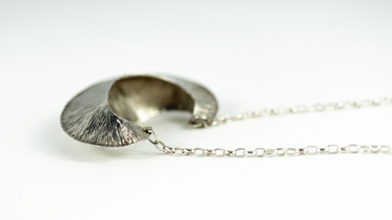 This striking Silver Pod Pendant is made from sterling silver and is perfectly lightweight. This is an elegant look for any day of the week! Alternate side view.