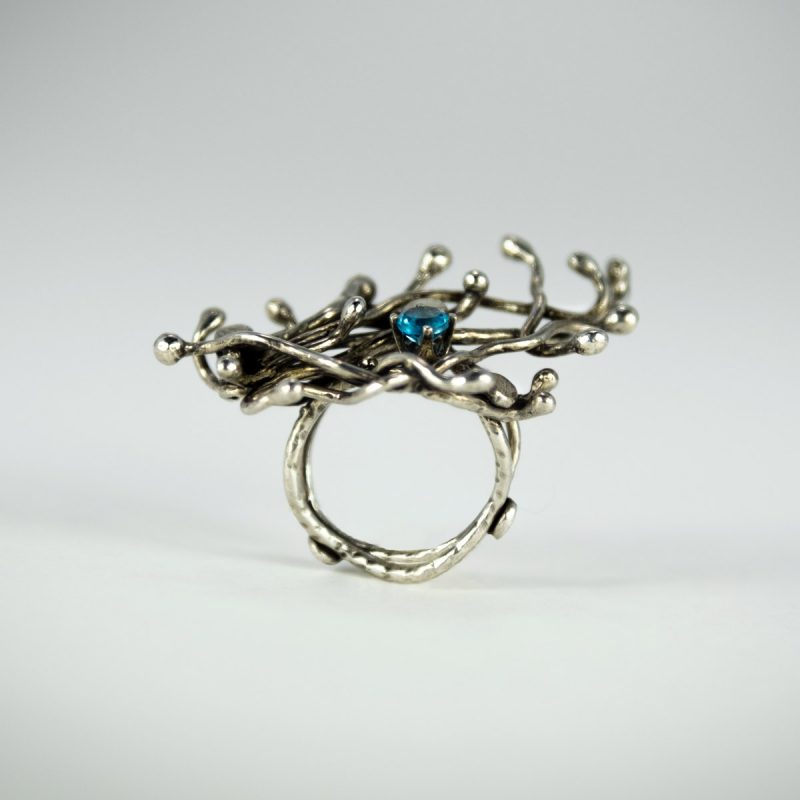 This wildly alluring Silver Sprout Ring is made from sterling silver and set with Blue Topaz Faceted Stone. Oxidized and polished for an eye-catching look!