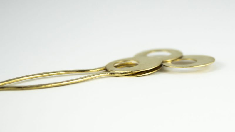 Stylish Brass Hair Fork Olives side view.